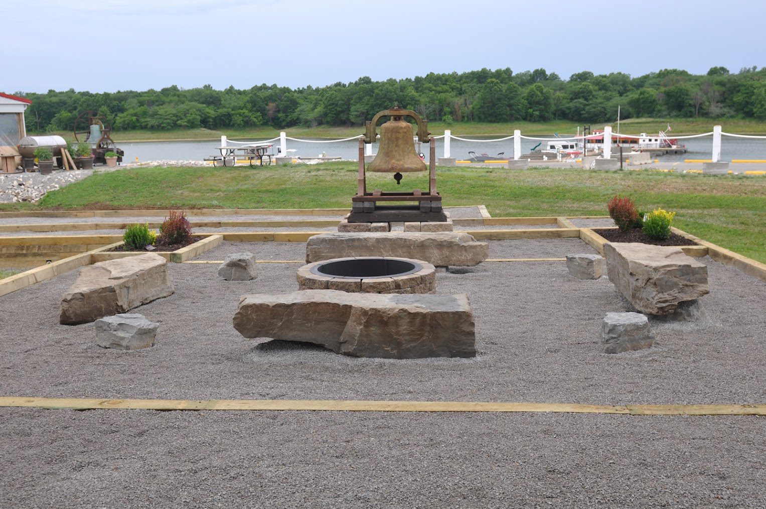 Bell and fire pit in stone garden.