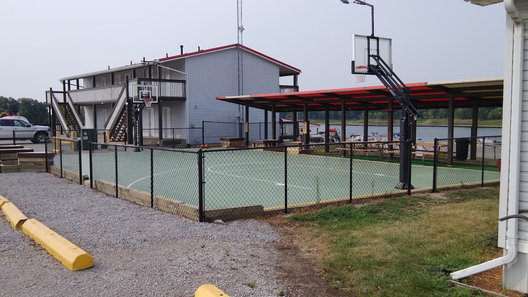 Outdoor basketball court with hoop.