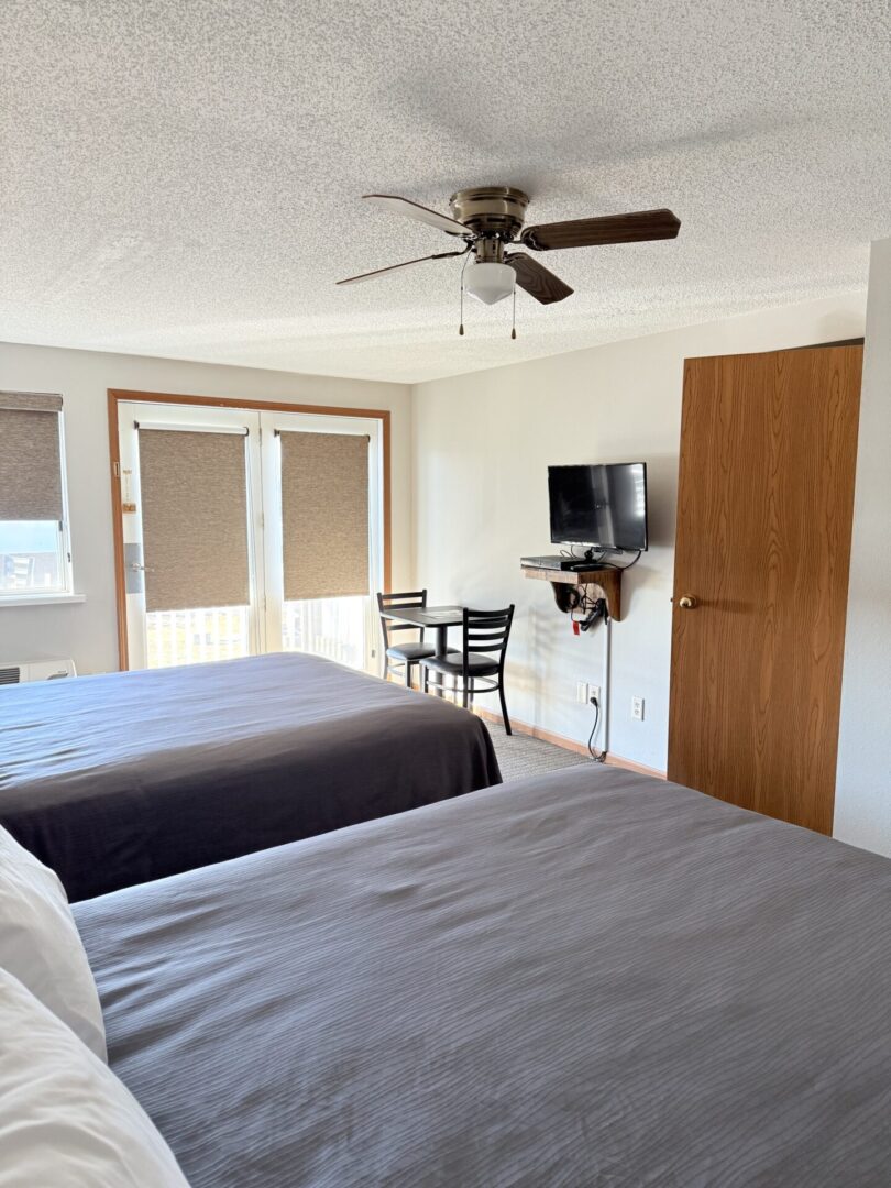 Hotel room with two beds and TV.