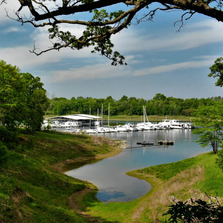 A river with boats docked in it near the shore.