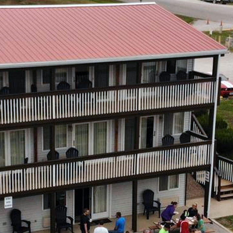 A group of people standing outside of a building.